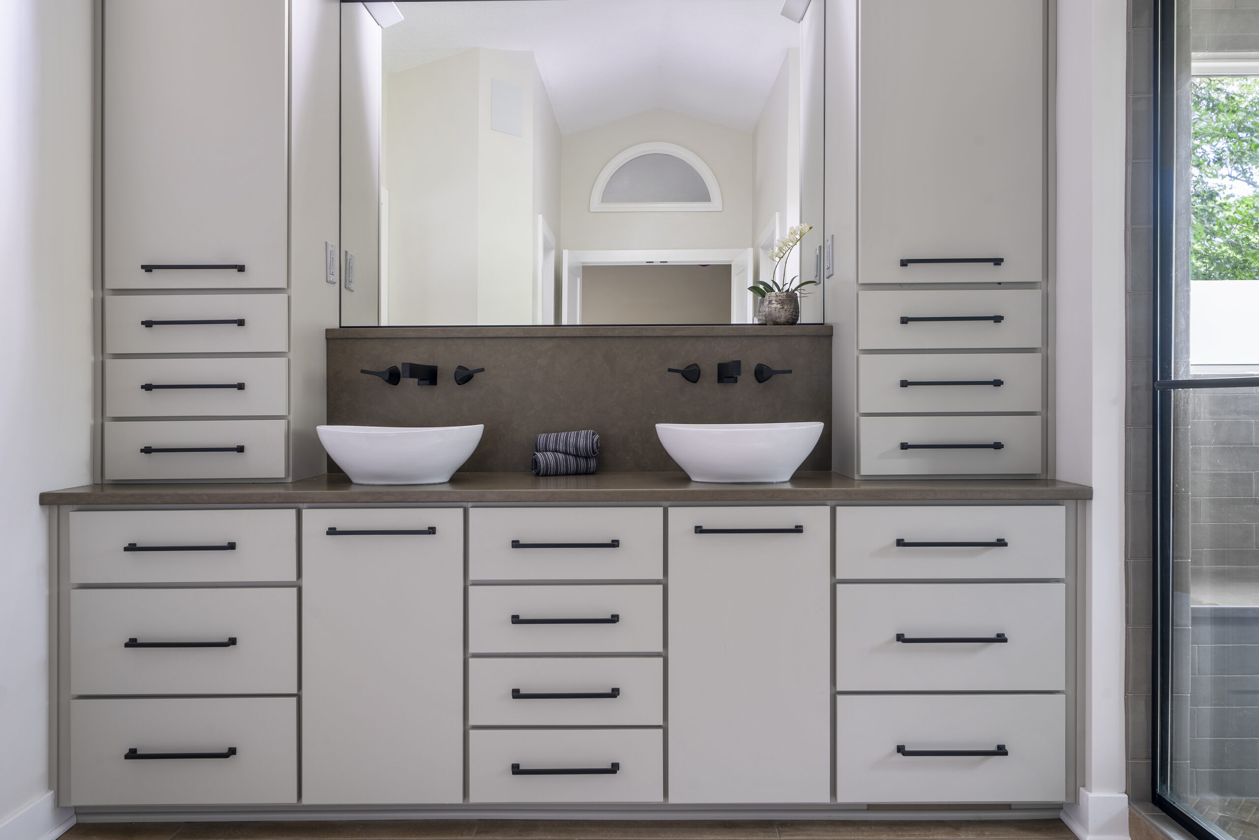 Custom bathroom vanity with dual pedestal sinks.