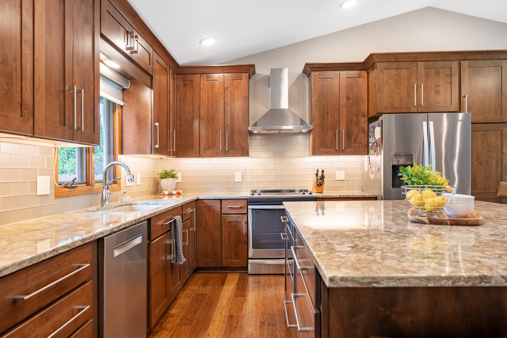 Kitchen with wood cabinetry and quartz countertops